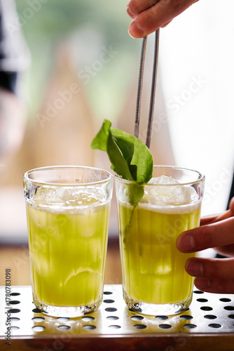 Making atmospheric rustic cocktails in faceted glasses