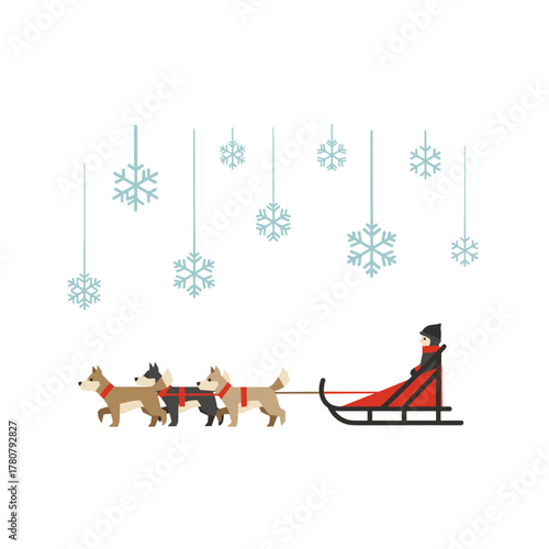 Sled dogs running through fresh powder snow with snowflakes above  