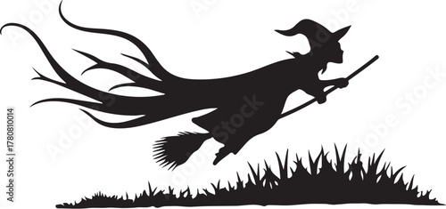 Black silhouette of a witch flying on a broomstick over gras