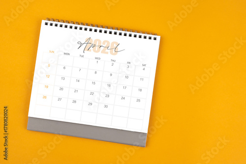 Wallpaper Mural Top view of April 2026 desk calendar on yellow color background. Torontodigital.ca