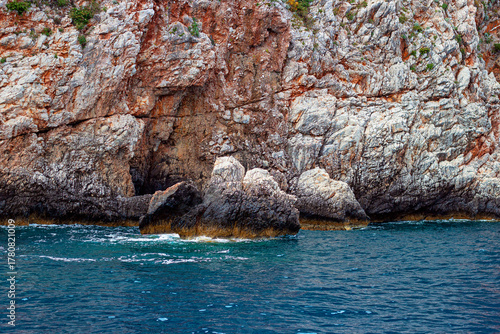 Fototapeta Naklejka Na Ścianę i Meble -  Pale Cliffs of Suluada Island along the Mediterranean Coast, Marked with Subtle Reddish Veins, Antalya, Turkey