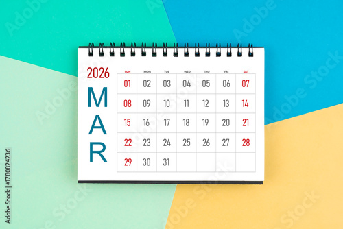 March 2026 month blank desk calendar on colorful background, Flat lay.