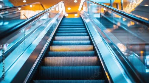 Detailed view of escalator handrails and steps in a contemporary shopping mall, emphasizing motion and modern design