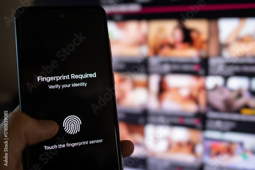 Hand using smartphone for identity verification and adult content access