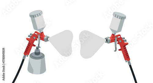 Airbrush tools with red handles and spray mist on white background