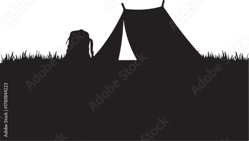 Black silhouette of a tent and backpack on grass camping