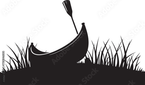 Black silhouette of canoe and paddle in grass boat