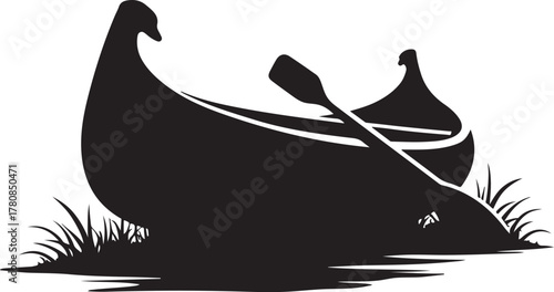 Two black canoes with paddle on grassy shore kayak