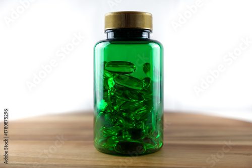 Green plastic bottle with vitamins