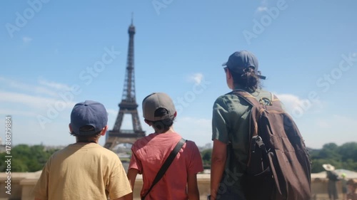 Family sightseeing the eiffel tower from a parisian street, parents and children enjoying a summer city break, strolling and discovering the iconic landmark together