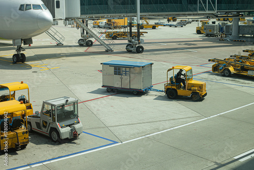 Multiple aircraft pushback tractors and ground support vehicles parked on the tarmac at an airport, ready for aircraft towing and ground operations.