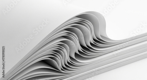 Dynamic Close-up of Curled Stacked White Paper Sheets Texture
A mesmerizing close-up shot of a stack of bright white paper sheets where the top section is curling and folding back onto itself