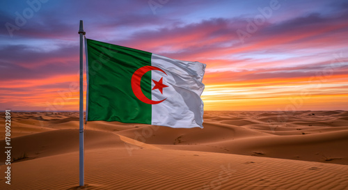 Fototapeta Naklejka Na Ścianę i Meble -  Algerian Flag in Desert Dunes at Sunset