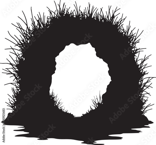 Black silhouette of a cave entrance with grass and water