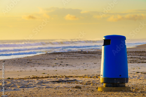 Empty beach with trash can