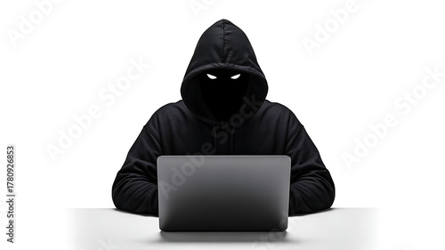 Anonymous hooded figure sitting in front of a laptop computer with a blacked-out face, symbolizing a hacker, cybercrime, dark web, security threats, and digital danger.
