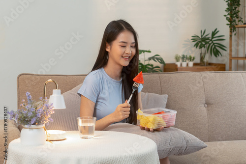 Woman enjoying fresh fruit at home