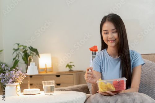 Woman enjoying fresh fruit at home