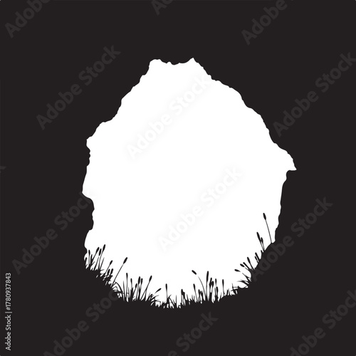 Black silhouette of rocky cliff edge with grass black and white