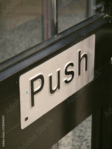 Silver Push Sign on Glass Door