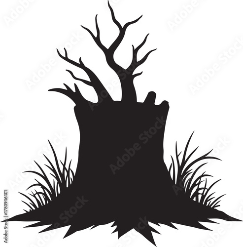 Black silhouette of a dead tree stump with bare branches and grass