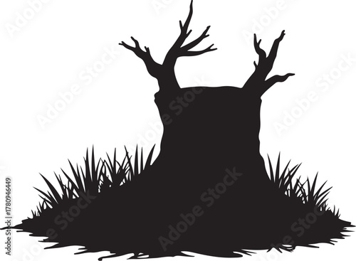 Black silhouette of a dead tree stump with grass black and white