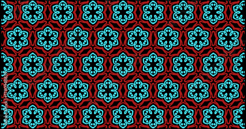 Bold floral geometric pattern in turquoise and red, arranged in a seamless symmetrical layout with stylized petals and dark background for a striking decorative look.