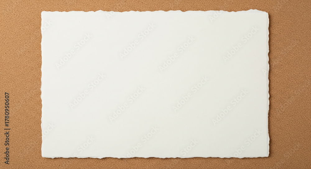 Fototapeta premium Blank Rough Edge Handmade Paper Card on Brown TextureAn elegant, minimalist overhead shot of a single blank piece of handmade paper with distinctive, deckled edges