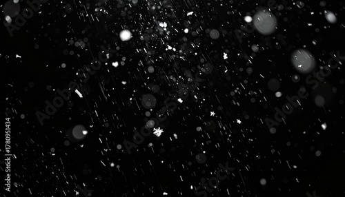Falling snow against a black background, creating a magical atmosphere