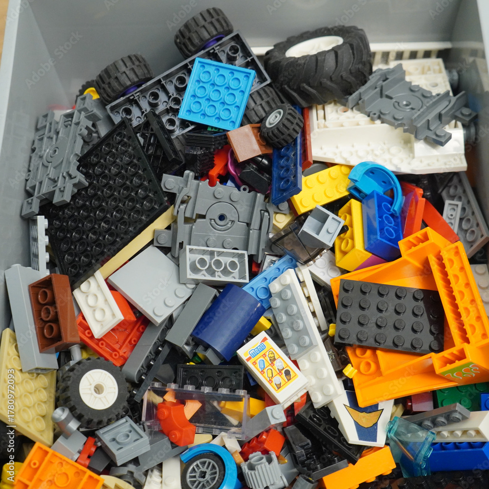 Fototapeta premium Colorful assortment of toy building blocks in a storage container