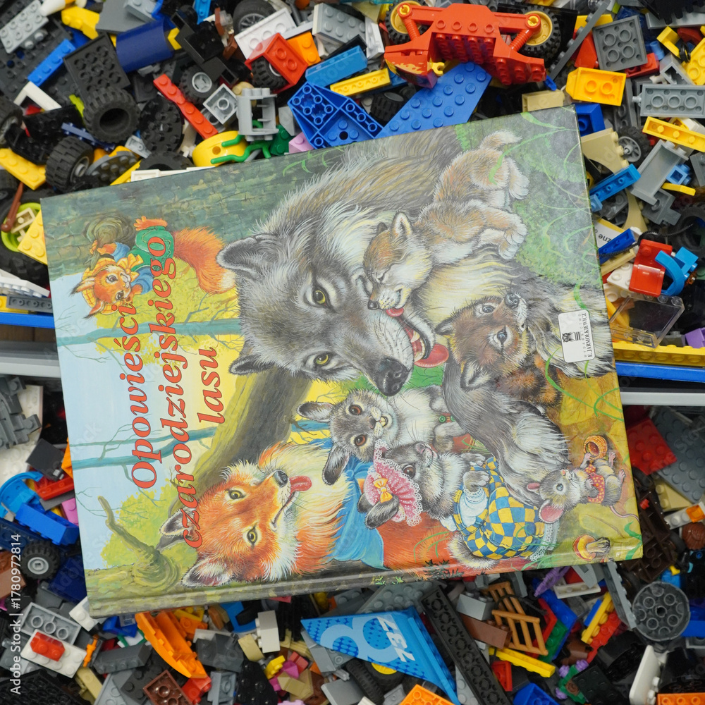 Obraz premium Colorful children's book with forest animals on a pile of colorful toy blocks