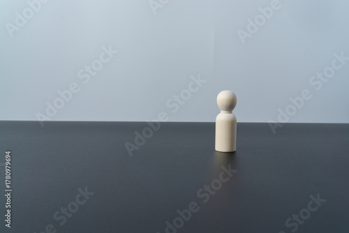 Single wooden doll figures on black and white background
