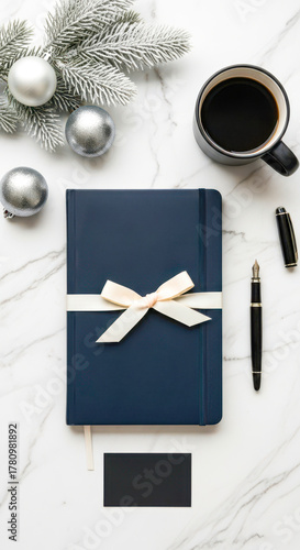 Elegant Desk Setup with Navy Notebook, Coffee, and Silver Ornaments on Marble