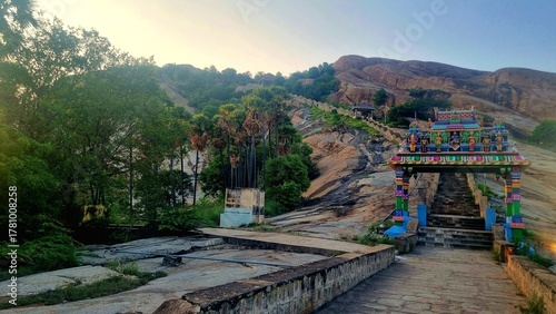 Colorful kasi viswanathar temple entrance and stone steps leading up Thiruparankundram Hill in Madurai, Tamil Nadu, showcasing the natural rock landscape and peaceful spiritual atmosphere