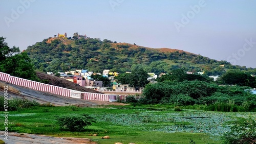 Colorful kasi viswanathar temple entrance and stone steps leading up Thiruparankundram Hill in Madurai, Tamil Nadu, showcasing the natural rock landscape and peaceful spiritual atmosphere