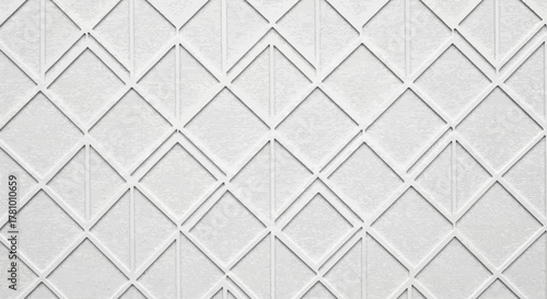 Minimalist white architectural background featuring a clean repeating geometric diamond and chevron pattern, creating a modern, elegant textured surface for contemporary design