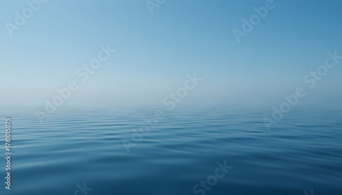 Clear blue sky reflected in calm water surface.