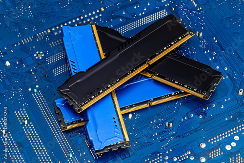Принти на полотні Four DDR memory chips in different colors lying on a blue printed circuit board