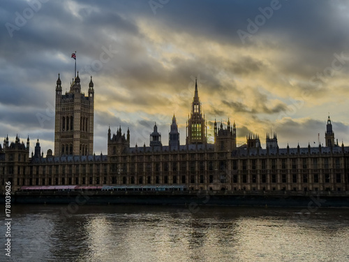 Beautiful night an Sunset view of Big Ben and the Houses of Parliament in London, illuminated over the River Thames with city lights reflecting on the water. UK