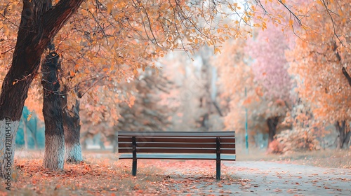 Fototapeta Naklejka Na Ścianę i Meble -  Tranquil Autumn Park Scene Wooden Bench Golden Fall Foliage Background