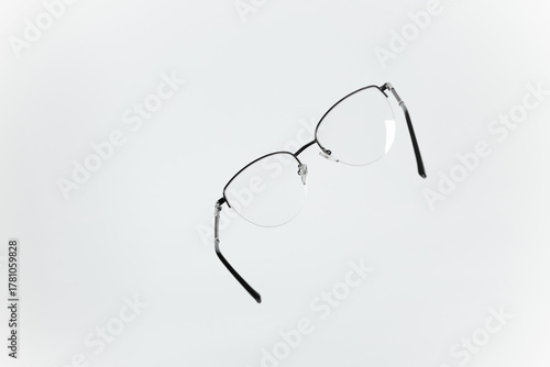 Stylish women’s eyeglasses with thin metal semi-rim frame on white background. Vsion correction concept.