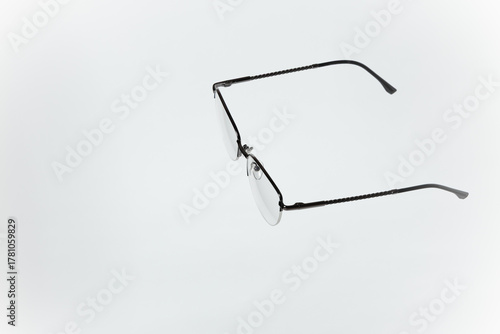 Stylish women’s eyeglasses with thin metal semi-rim frame on white background. Vsion correction concept.