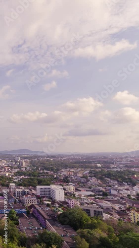vertical timelapse aerial view of phuket town city skyline with many buildings housing in the central business district with background of bay area and seascape ocean in daytime.phuket city skyline