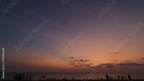 timelapse while people relaxing on the white sand beach during Summer Vacation sunset time at tropical beach in Karon,Phuket. People in vacations on a beautiful beach during summer sunset time