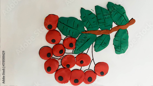 Application of a rowan tree branch with red berries and green leaves made of plasticine