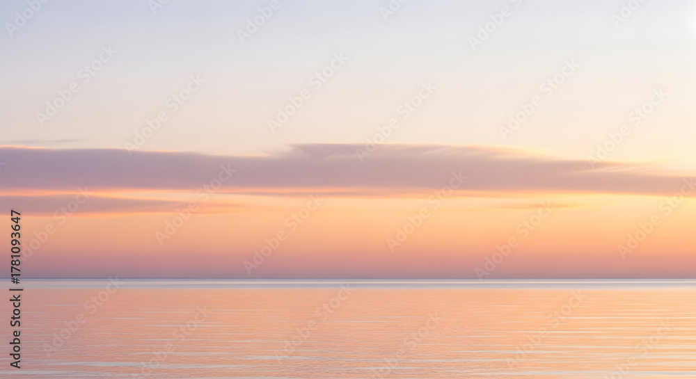 Fototapeta premium Soft Pastel Sunset Over A Calm Ocean Horizon water