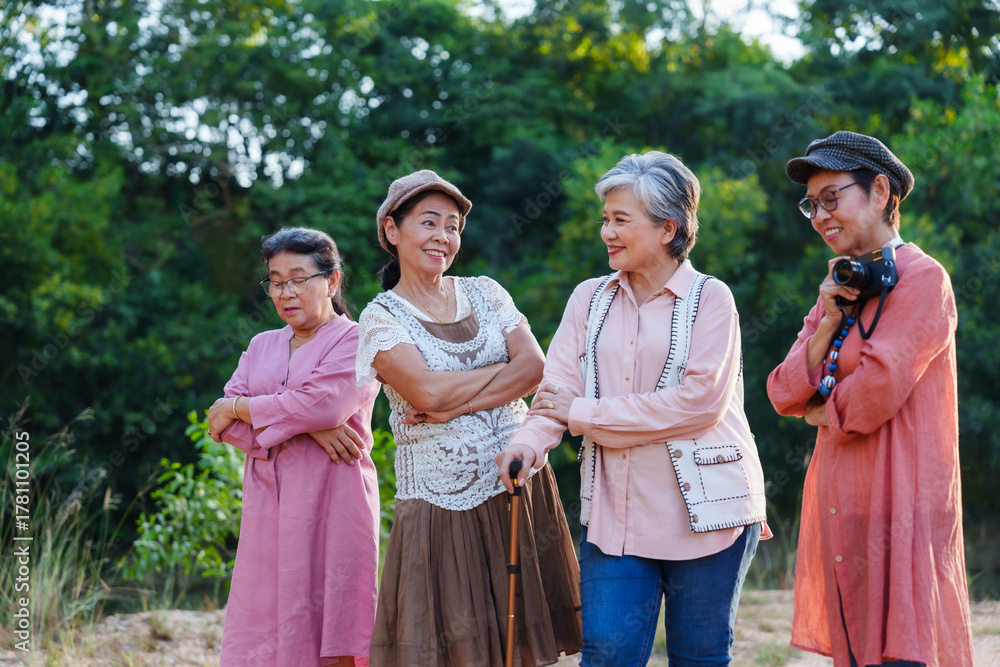 Naklejka premium Senior Asian women standing posing arms crossed cheerful smiling outdoor casual clothing nature vacation adventure travel leisure lifestyle freedom exploration friendship journey refreshing happiness