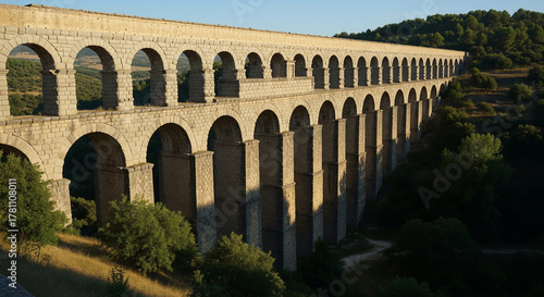 Ancient Stone Arch Aqueduct Spanning a Valley in the European Countryside

A breathtaking view of a massive ancient Roman aqueduct