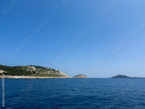 Fototapeta Naklejka Na Ścianę i Meble -  Tranquil Seascape with Rocky Islands and Azure Sky