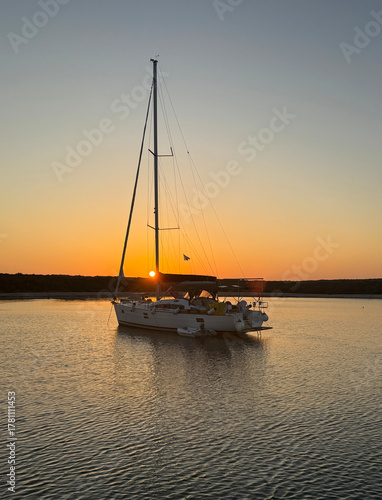 Sailboat Silhouetted Against a Golden Sunset